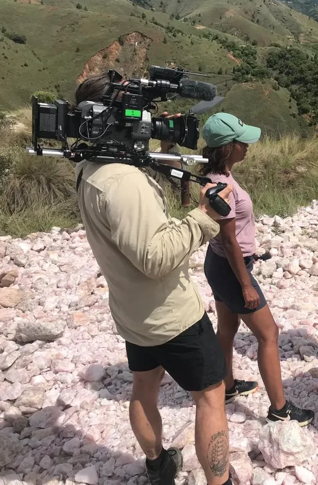 Camera operator and presenter filming at a rose quartz site in the highlands of Madagascar